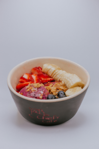 A bowl with banana, blueberrys ,oatmeal and strawberries on it