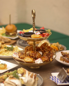 A table with various plates on it, and a bowl of pastries in the middle